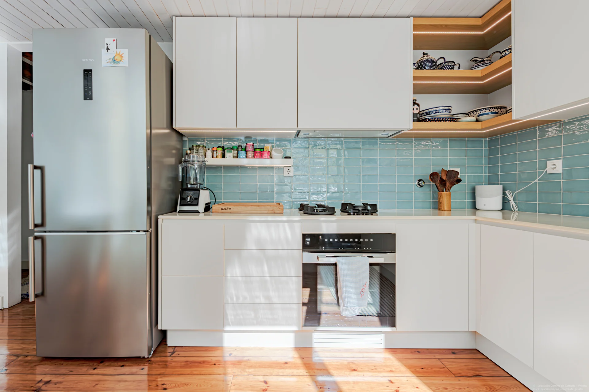 Kitchen with teal backsplash and timber floor