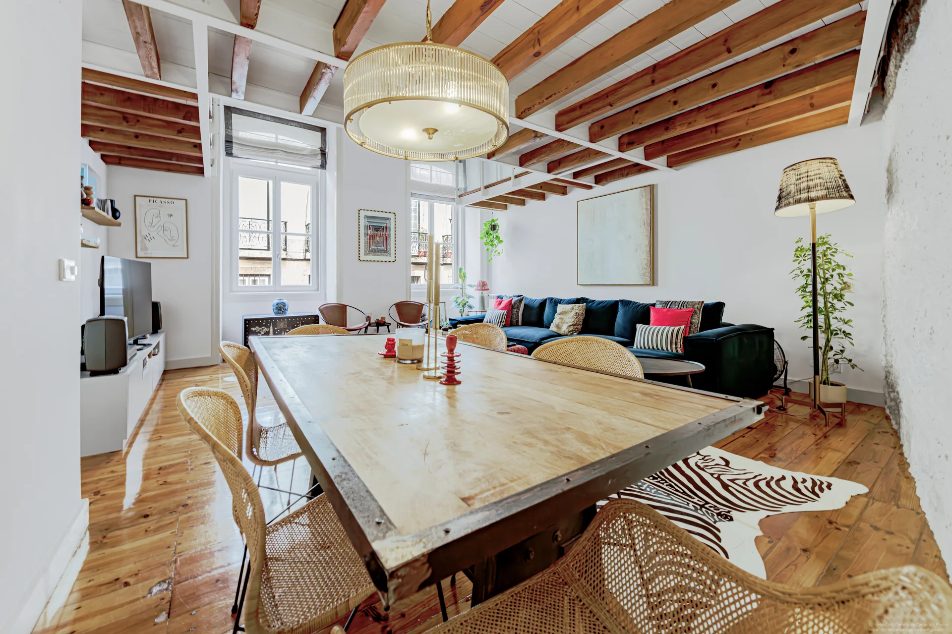 Living room with navy sofa and exposed beams