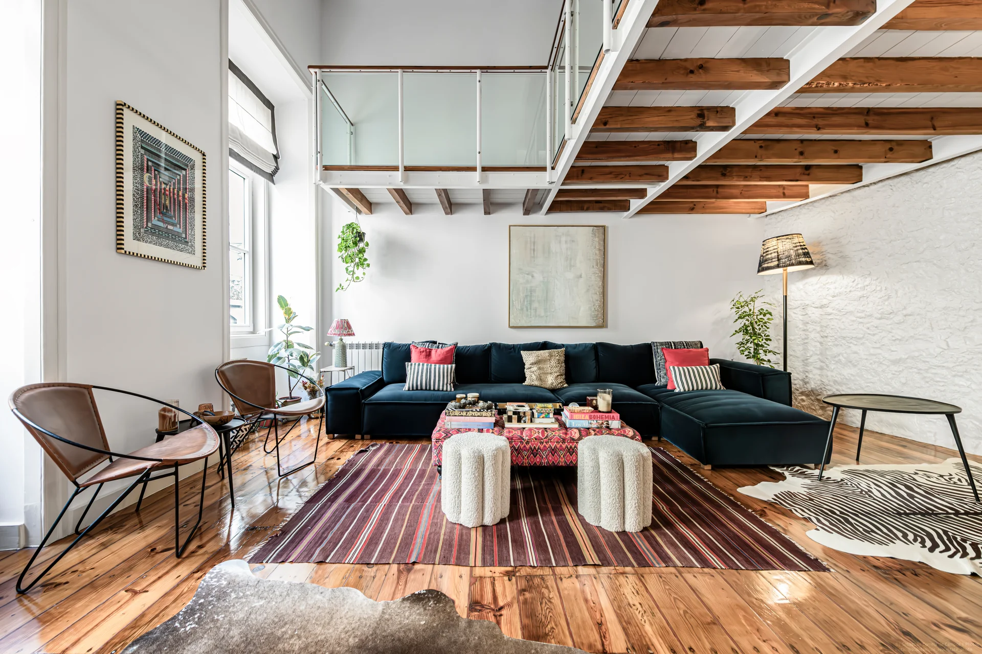 Living room with exposed beams and mezzanine